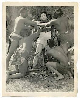 Houdini, Harry. Movie Still of Houdini Being Tied by Natives in Terror Island. Los Angeles, [1920].