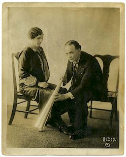 Houdini, Harry. Sepia Photo of Houdini Holding a Spirit Trumpet. Chicago: Butler Studio, ca. 1920. P