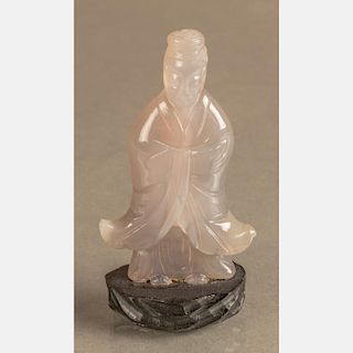 A Chinese Carved Agate Figure of an Elder on a Carved Hardwood Stand.