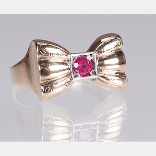 A 10kt. Yellow Gold and Ruby Bow Form Ring,