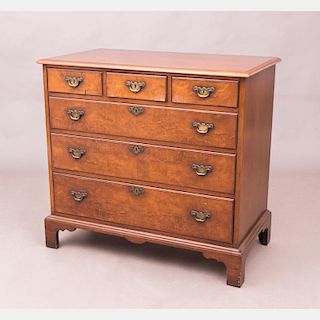 A Georgian Style Mahogany and Burled Veneer Chest of Drawers, 20th Century.