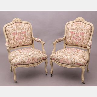 A Pair of Louis XV Style Painted Hardwood Fauteuils, 20th Century.