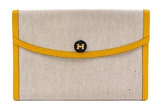 * An Hermes Cream Toile and Yellow Leather Rio Clutch, 8.5" x 6" x 1.5".