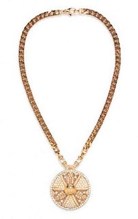 A Gianni Versace Rose Goldtone Pendant Necklace, 22" length, 2.5" pendant diameter.
