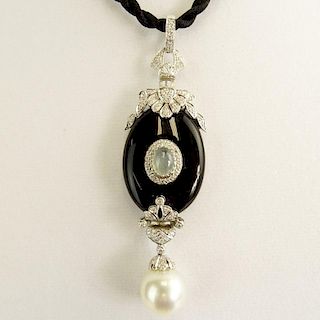 Modern Art Deco style South Sea Pearl, Black Onyx, 18 Karat White Gold Pendant accented with small round cut diamonds.