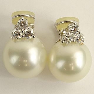 Pair of 15.6-15.9mm South Sea Pearl and 18 Karat White Gold Earclips with Three (3) Round Brilliant Cut Diamonds.