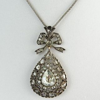 Antique Diamond, Gold and Silver Pendant Necklace set in the Center with a Pear Shape Diamond and accented with Rose Cut Diamonds.