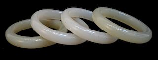Four White And Light Yellow Jade Bangles