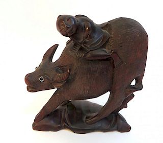 Wooden Carving Of A Man Riding An Ox