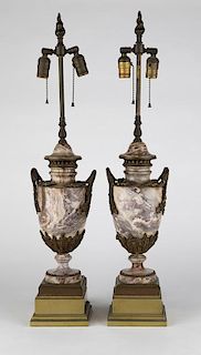 A pair of gilt bronze-mounted carved stone lamps
