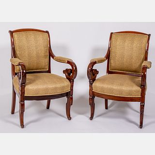 A Pair of Regency Carved Mahogany Arm Chairs