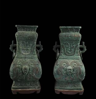 A pair of heavy bronze wine vessel