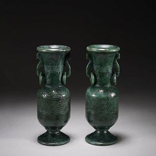 A pair of green jade vases