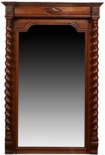 French Louis XIII Style Carved Walnut Overmantel Mirror, c. 1900, the stepped crown over an applied geometric carving over a setback wide beveled arch