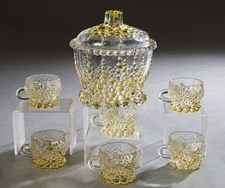 French Seven Piece Molded Yellow and Clear Glass Punch Set, 20th c., consisting of a covered punch bowl with relief grape decoration and 6 matching cu