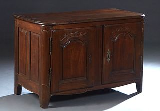 French Provincial Louis Philippe Carved Oak Sideboard, 19th c., the rounded corner top over double fielded panel cupboard doors with iron fiche hinges