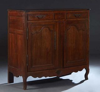 French Provincial Louis XV Style Carved Cherry Sideboard, early 19th c., the canted corner top over three frieze drawers and double cupboard doors wit