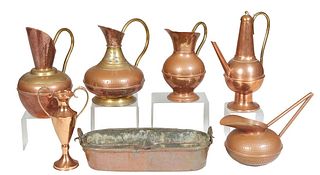 Group of Seven Copper Kitchen Items, 20th c., consisting of three brass handled pitchers; a loving cup with brass handles; a hand hammered copper pitc
