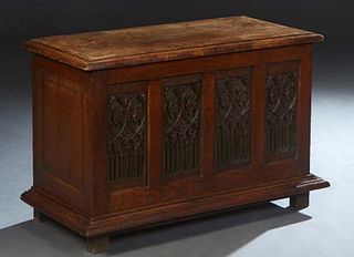 French Provincial Renaissance Style Carved Oak Coffer, 19th c., the stepped lifting lid over a front with four Gothic carved panels, on a stepped base