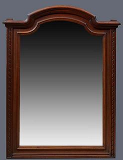 French Louis XVI Style Carved Walnut Overmantel Mirror, late 19th c., the stepped arched crown over a twist carved frame around an arched wide beveled