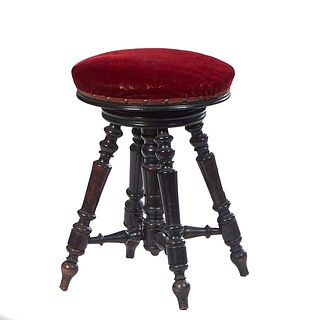French Ebonized Adjustable Piano Stool, late 19th c., the circular magenta velvet upholstered adjustable seat, on four splayed legs, joined by turned 