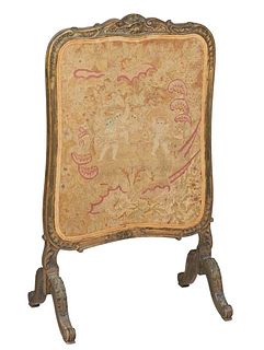 French Louis XV Style Carved Walnut Firescreen, 19th c., the shell and leaf carved frame around the original needlework panel depicting four putti and