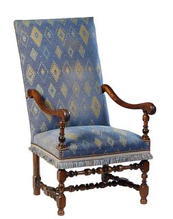 French Louis XIII Style Carved Walnut Fauteuil a la Reine, 20th c., the rectangular high canted upholstered back to an upholstered seat flanked by scr