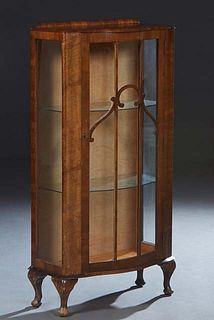 Diminutive English Carved Walnut Curio Cabinet, c. 1940, the rounded top over a bowed door with three mullioned glass panes, flanked by glazed sides, 