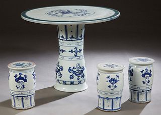 Chinese Porcelain Four Piece Patio Set, 20th c., consisting of a circular table with bird and floral decoration and three cylindrical stools, H.- 29 1