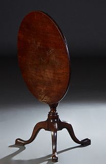 English Carved Mahogany Queen Anne Style Tilt Top Tea Table, 19th c., the circular top on a turned tapered cylindrical support to tripodal cabriole le