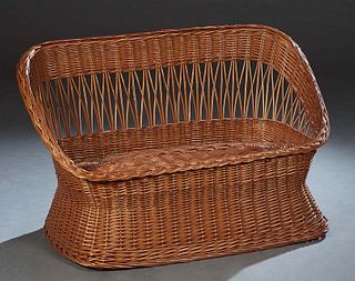 Bent Woven Wicker Settee, 20th c., with a curved back with a rolled crest rail flanked by rolled arms, joined by a woven wicker seat and base, H.- 28 