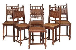 Set of Six French Henri II Style Oak Dining Chairs, c. 1880, with a lion carved spindled crest rail over a reeded horizontal splat, above a trapezoida
