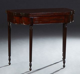 English Carved Mahogany Games Table, early 20th c., the shaped rounded corner top over a wide skirt, on reeded tapered cylindrical legs, H.- 30 1/8 in