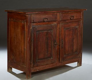 French Provincial Carved Walnut Sideboard, 19th c., the rounded edge and corner two board top over two setback frieze drawers, above fielded panel dou