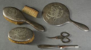 Six Piece Assembled Lady's Sterling Dresser Set, early 20th c., consisting of a hand mirror, clothes brush, hair brush and curling iron, each engraved