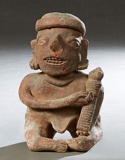 Pre-Columbian Pottery Figure, of a seated man using a grater, H.- 10 in., W.- 6 in., D.- 4 1/2 in. Provenance: Palmira, the Estate of Sarkis Kaltakdji