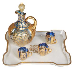 Four Piece Moser Cased Blue Glass Liqueur Set, consisting of a decanter and stopper with floral and leaf decoration, three diminutive like cups with h