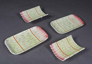 French Four Piece Majolica Asparagus Serving Set, late 19th c., consisting of two draining cradles and two underplates, with pink, creme and green rel
