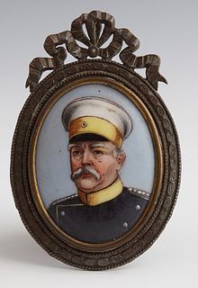 Porcelain Portrait Miniature of a German Naval Captain, early 20th c., presented in a brass frame with a bowl and garland surmount, Plaque- H.- 2 1/8 