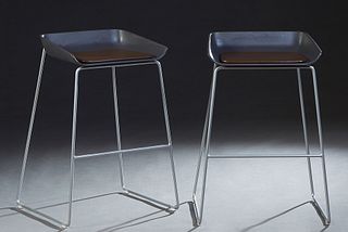 Pair of Turnstone Scoop Barstools, 21st c., with gray plastic seats with vinyl cushions, on cylindrical steel legs, joined by cylindrical steel stretc