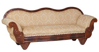 American Classical Carved Mahogany Settee, 19th c., the serpentine back to upholstered rolled arms, with scrolled supports, to a bowed seat, on applie