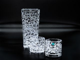 Tiffany & Co crystal set Tiffany & Co set of rock cut crystal candle holders and tall vase, signed and appear to be in overall good condition circa 19