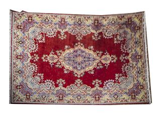 Persian kirman rug Mid 20th century Polychromed Persian Kirman rug, fringed ends, floral motifs throughout, center medallion and 2 guard boarders 
(A