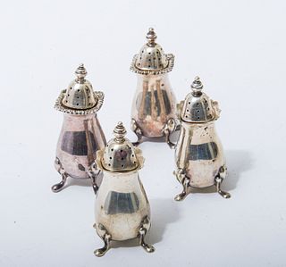 Four sterling silver footed salt & pepper shakers Four sterling silver footed salt & pepper shakers retailed by Tiffany & Co bearing London hallmarks 
