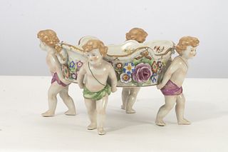 Von Schierholz Cupid Bowl Von Schierholz polychromed hard paste porcelain centerpiece figural group raised on 4 figures of Putti (cupid)
6" x 12.5" d
