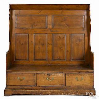 English pine settle, late 18th c., with a raised panel back and a three-drawer base, 65'' h.