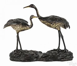 Japanese bronze cranes mounted on a carved wooden bases, 16 1/2'' h., 19 1/2'' w.