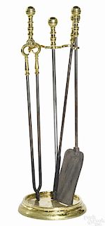 Set of Federal brass and iron fire tools, ca. 1820, to include a stand, 27 1/2'' h., tongs
