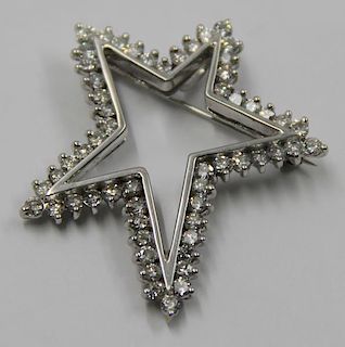 JEWELRY. 18kt Gold and Diamond Star Form Brooch.