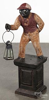 Painted cast iron jockey hitching post, late 19th c., together with a tin hanging lantern, 38'' h.